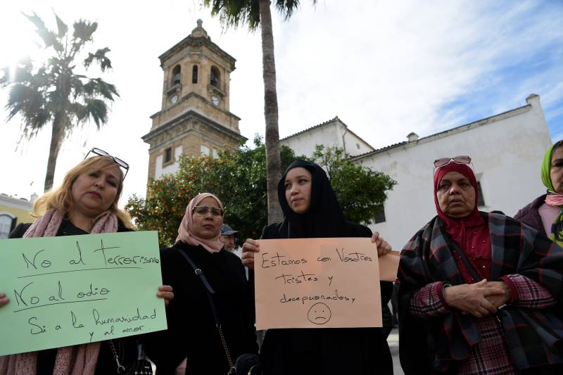 Muslim women hold signs reading 'No to terrorism, yes to humanity and love' and 'we are with you, we are sad' near the church where a man was killed in Alta square, in Algeciras, southern Spain. AFP