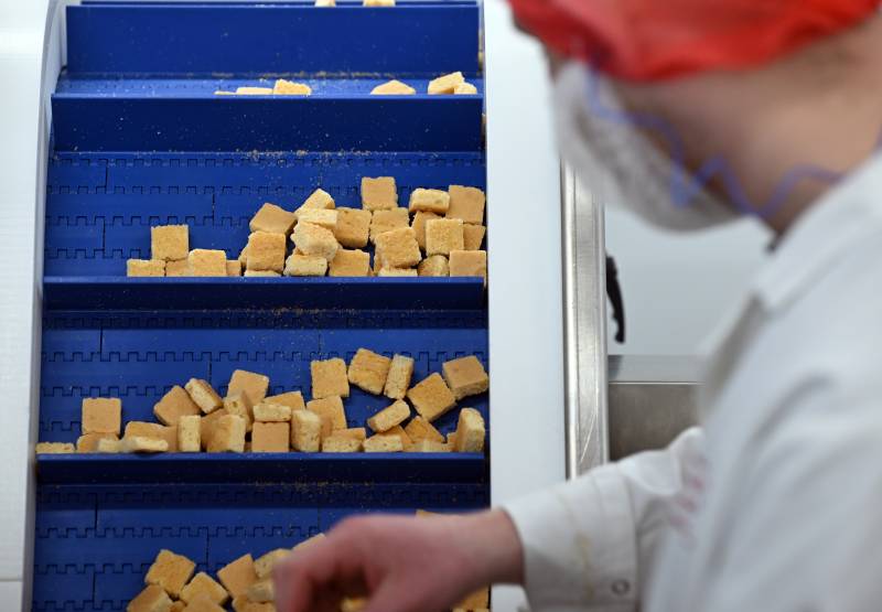 Employees work at Pecan Deluxe Candy's manufacturing site in Sherburn-in-Elmet, northern England. AFP