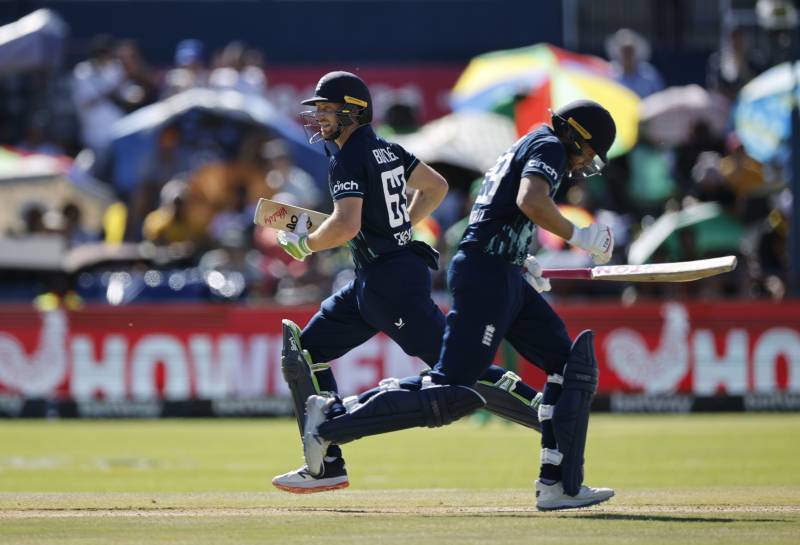 England's Captain Jos Buttler (L) runs between the wickets with England's Dawid Malan during the third one day international (ODI) cricket match between South Africa and England at Mangaung Oval in Kimberley. AFP