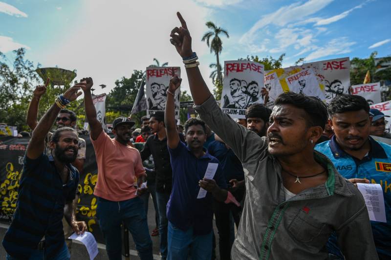 Anti-government demonstrators and university students shout slogans as they take part in a protest demanding the release of Inter University Students' Federation leaders in Colombo. AFP