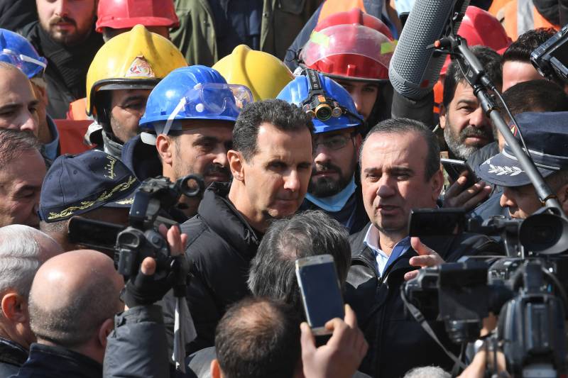 Syrian President Bashar al-Assad (C) visits neighbourhoods affected by an earthquake in the northern city of Aleppo. AFP