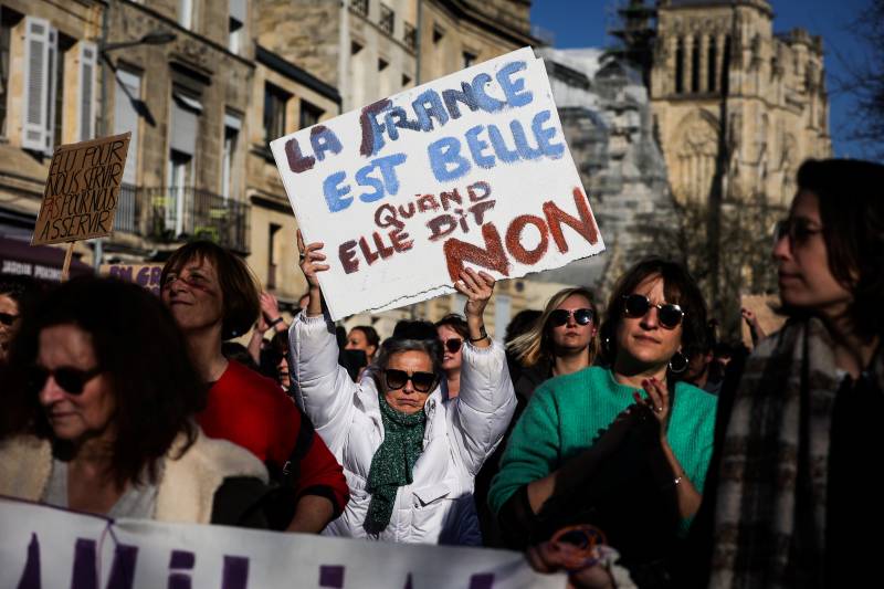 A protester holds a placard reading 