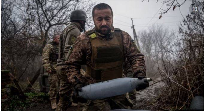 In this file photo, a Ukrainian artilleryman carries a 122-mm shell for a 2S1 Gvozdika self-propelled howitzer at a position along the front line near Bakhmut on December 10. AFP 