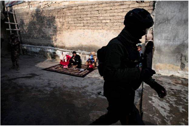 In this file photo, a member of the Syrian Kurdish Asayish security forces walks past a house during a raid against suspected Islamic State group fighters in Raqa in Syria on January 29, 2023. AFP 