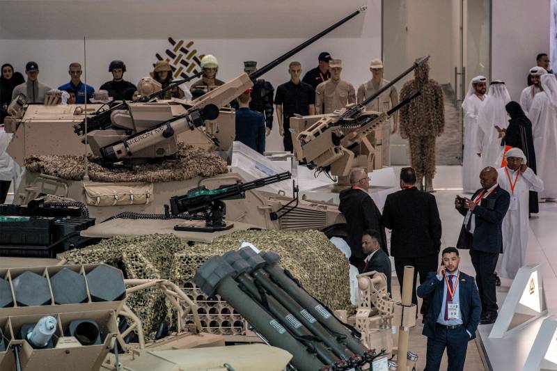 Visitors tour past unmanned ground combat vehicles near the EDGE pavilion during the International Defence Exhibtion (IDEX) at the Abu Dhabi International Exhibition Centre. AFP