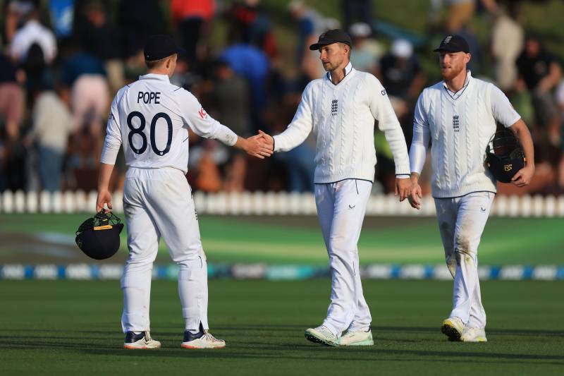 England's Ollie Pope (L) with team mates Joe Root (C) and captain Ben Stokes (R) walk from the field at the end of the day during day three of the second cricket test match between New Zealand and England at the Basin Reserve in Wellington on Sunday. AFP 