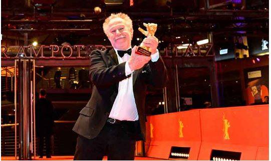 French director Nicolas Philibert poses with the “Golden Bear for Best Film