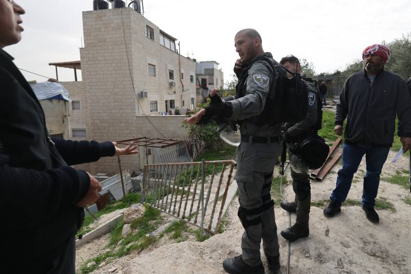 Israeli soldiers speak with relatives of Khayri Alqam outside his family home in the mostly Arab east Jerusalem neighbourhood of al-Tur. The home of the Palestinian man is to be demolished by Israeli authorities, even though his family says it was built with compensation paid to them after one of their relatives was killed by an Israeli. AFP