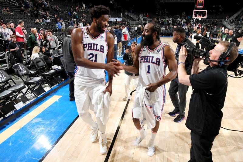 Joel Embiid #21 high fives James Harden #1 of the Philadelphia 76ers after the game against the Milwaukee Bucks on March 4, 2023 at the Fiserv Forum Center in Milwaukee, Wisconsin. AFP 