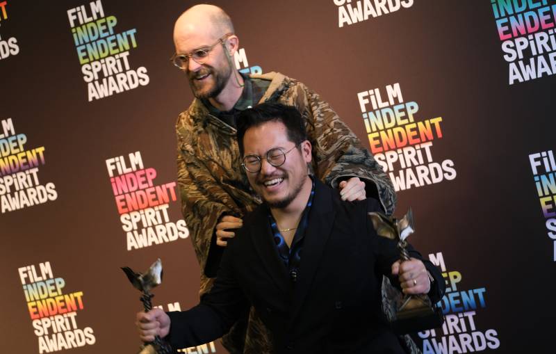 US director Daniel Scheinert (top) and US director Daniel Kwan pose with the Best Screenplay award for \