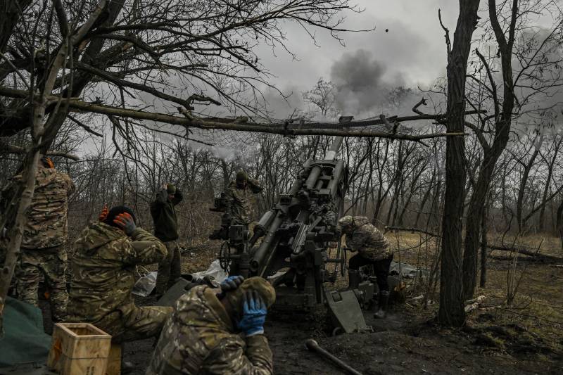 Ukrainian servicemen fire towards Russian positions with a 155mm M777 Howitzer artillery weapon on the front line somewhere near the city of Bakhmut on March 11, 2023 amid the Russian invasion of Ukraine. AFP