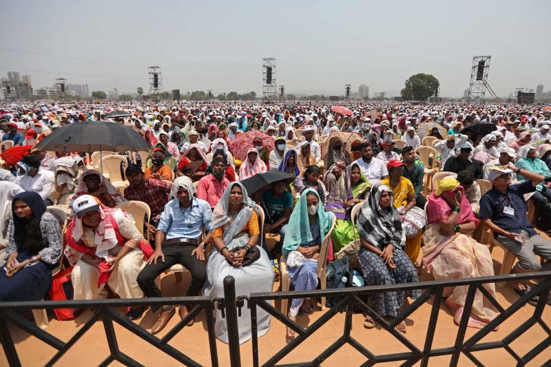 In this photograph taken on April 16, 2023, people gather to attend an award ceremony on the outskirts of Mumbai. AFP