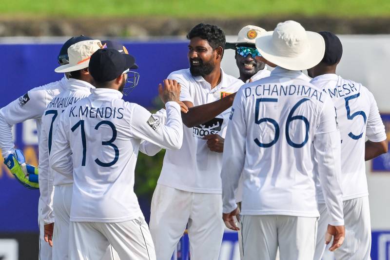 Sri Lanka's Prabath Jayasuriya (C) celebrates with teammates after taking the wicket of Ireland's Curtis Campher (not pictured) during the second day of the first cricket Test match between Sri Lanka and Ireland at the Galle International Cricket Stadium in Galle. AFP