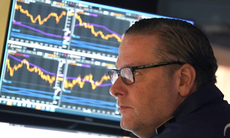 A trader on the floor at the New York Stock Exchange (NYSE) in New York during the opening bell on April 17, 2023. Stock markets traded mixed Monday over concerns that central banks may have to wait longer than expected to end their policy of raising interest rates. AFP