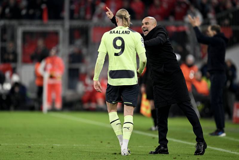 Manchester City's Spanish manager Pep Guardiola (R) gives instructions to his player Manchester City's Norwegian striker Erling Haaland during the UEFA Champions League quarter-final, second leg football match between Bayern Munich and Manchester City in Munich, southern Germany on April 19, 2023. AFP