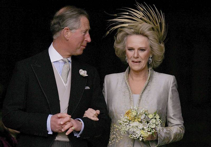 In this file photo taken on April 9, 2005 Britain's Prince Charles and his bride Camilla, Duchess of Cornwall leave St. George's Chapel in Windsor following the church blessing of their civil wedding ceremony. The coronation ceremony of Britain's King Charles III and his wife, Britain's Camilla, Queen Consort, as King and Queen of the United Kingdom and Commonwealth Realm nations is scheduled to take place at Westminster Abbey, in London, on May 6, 2023. AFP