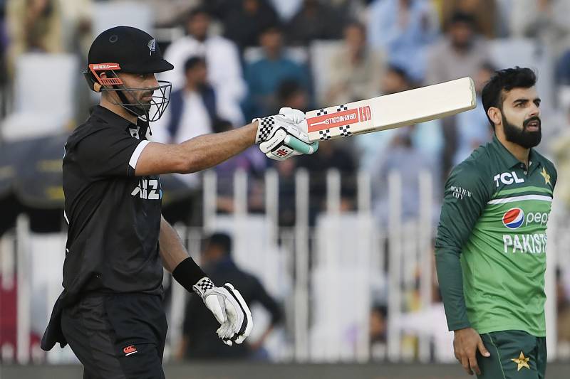 New Zealand's Daryl Mitchell (L) celebrates after scoring a half-century (50 runs) during the first one-day international (ODI) cricket match between Pakistan and New Zealand at the Rawalpindi Cricket Stadium in Rawalpindi. AFP