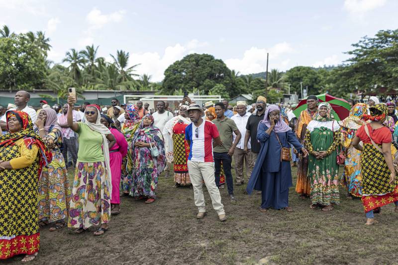 People gather to listen to a speech during a rally in support of Operation Wuambushu (