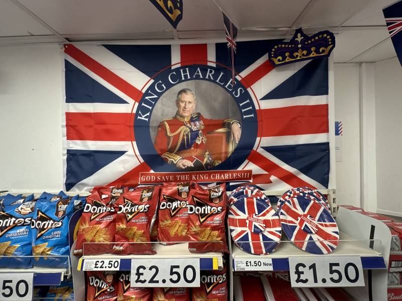 A Coronation-themed Union flag is pictured above bags of crisps displayed for sale inside a supermarket in in central London as preparations continue ahead of the May 6 Coronation of King Charles III. AFP