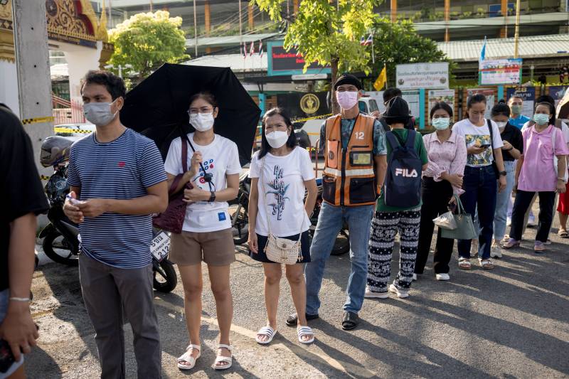 Voters queue to cast their ballot during advance voting at a polling station outside Wat That Thong Buddhist temple in Bangkok on May 7, 2023, a week ahead of the May 14 general election. AFP