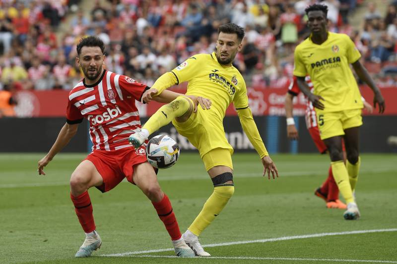 Girona's Spanish midfielder Ivan Martin (L) vies with Villarreal's Spanish midfielder Alex Baena during the Spanish league football match between Girona FC and Villarreal CF at the Montilivi stadium in Girona on May 20, 2023. AFP 