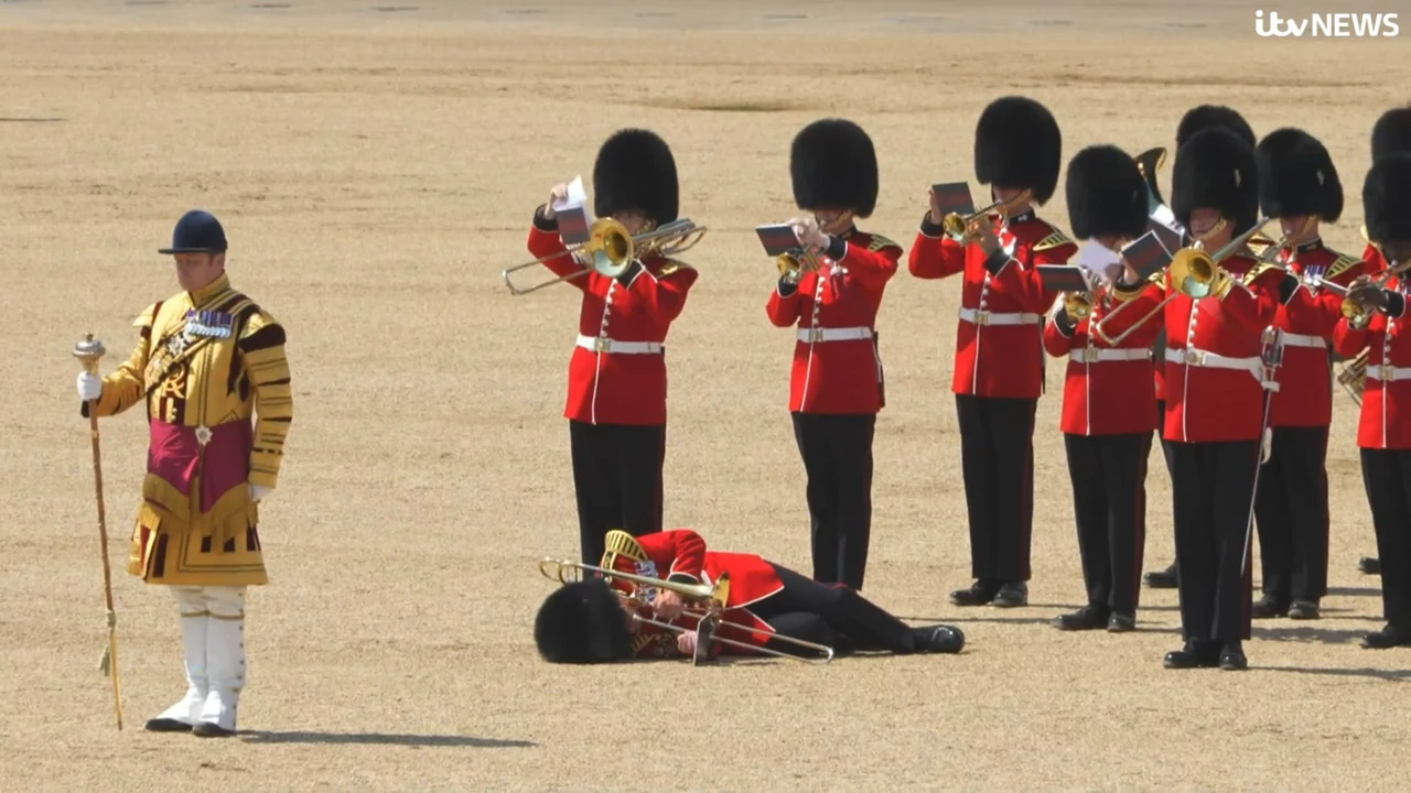 Trombonist soldier continues playing on after fainting due to heatwave in London