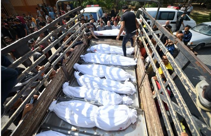 Gazans bury their dead in orchards and football fields