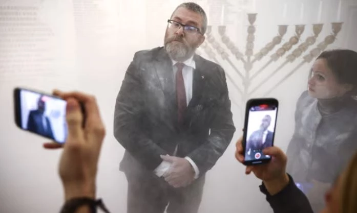 Polish far-right MP douses menorah with fire extinguisher