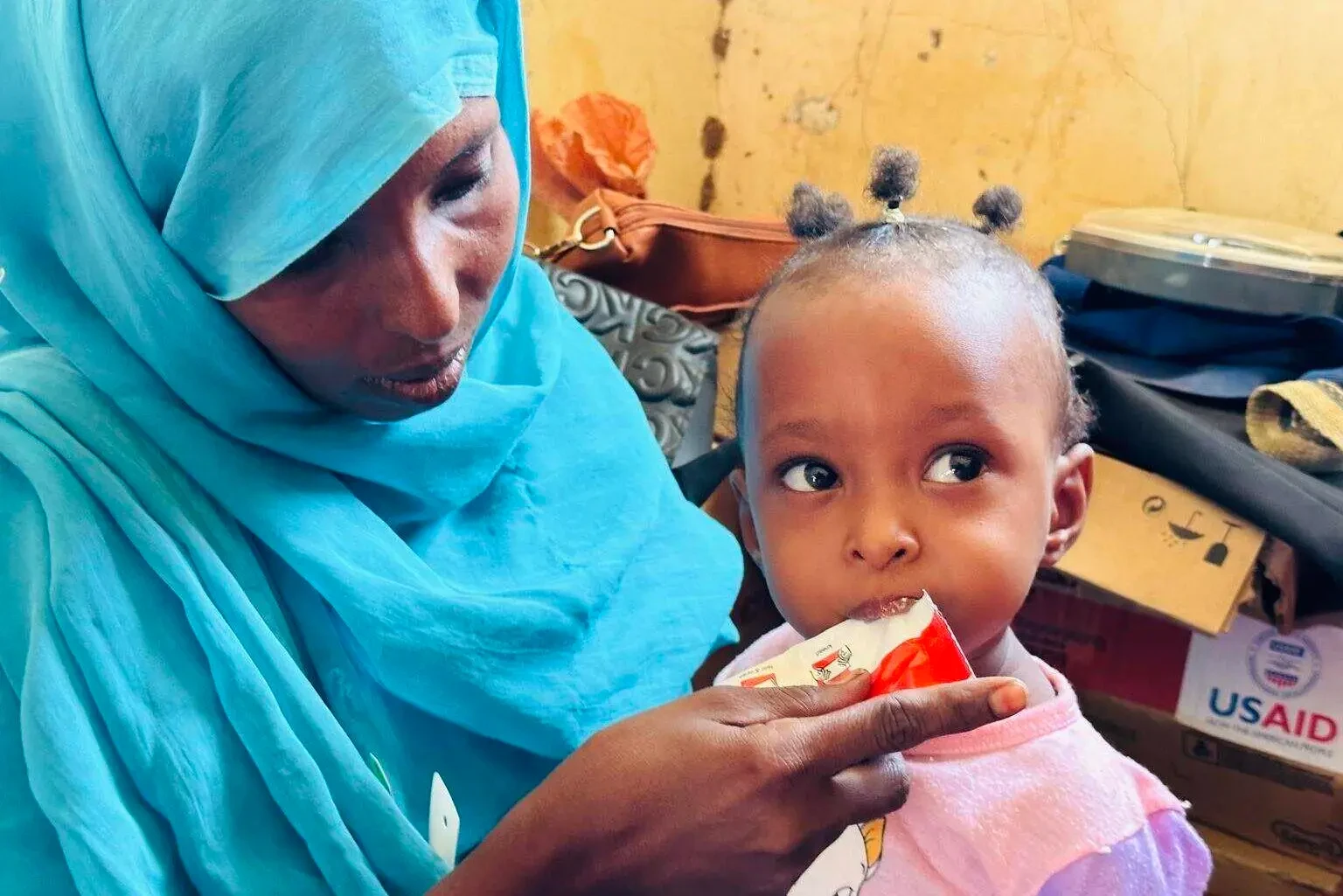 Under siege, Sudanese risk their lives to feed each other