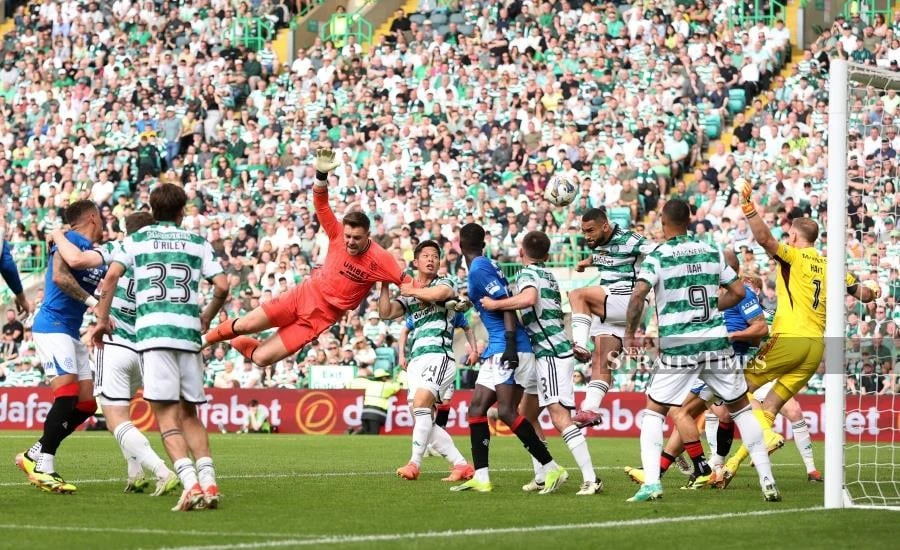 Celtic beat 10-man Rangers to virtually seal Scottish title