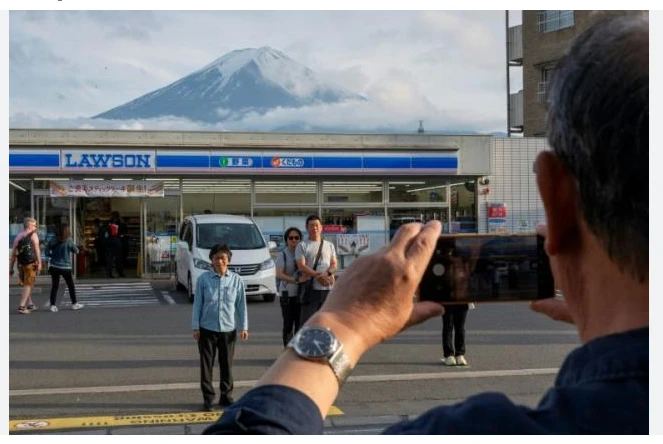 Sick of tourists, Japan town blocks view of Mt Fuji