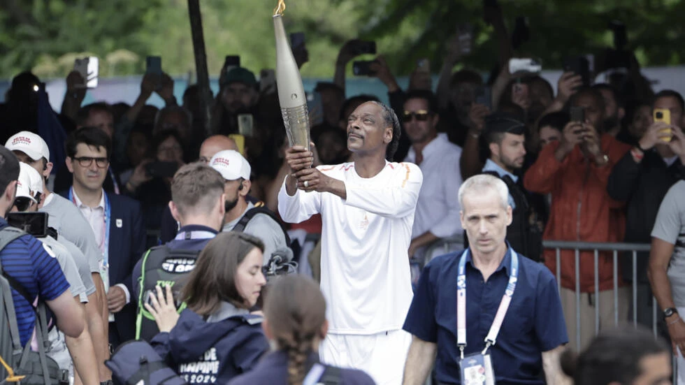 Flame lights up Paris opening ceremony with Snoop Dogg's star performance