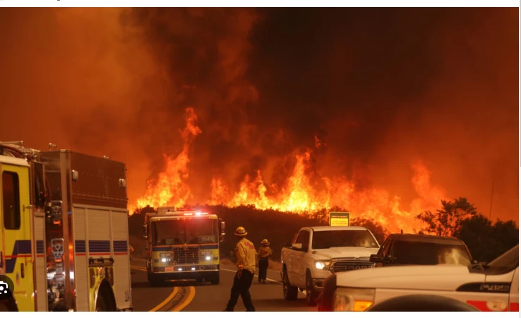 Los Angeles wildfire explodes, engulfing homes