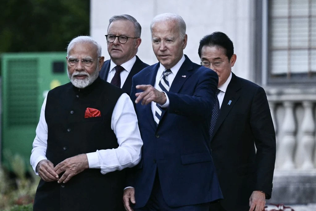 Biden says China 'testing us,' in hot mic remarks to Quad allies