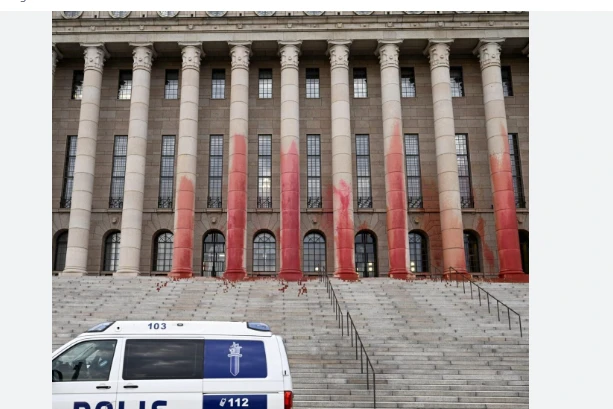 Environmentalists smear Finland's parliament in red paint