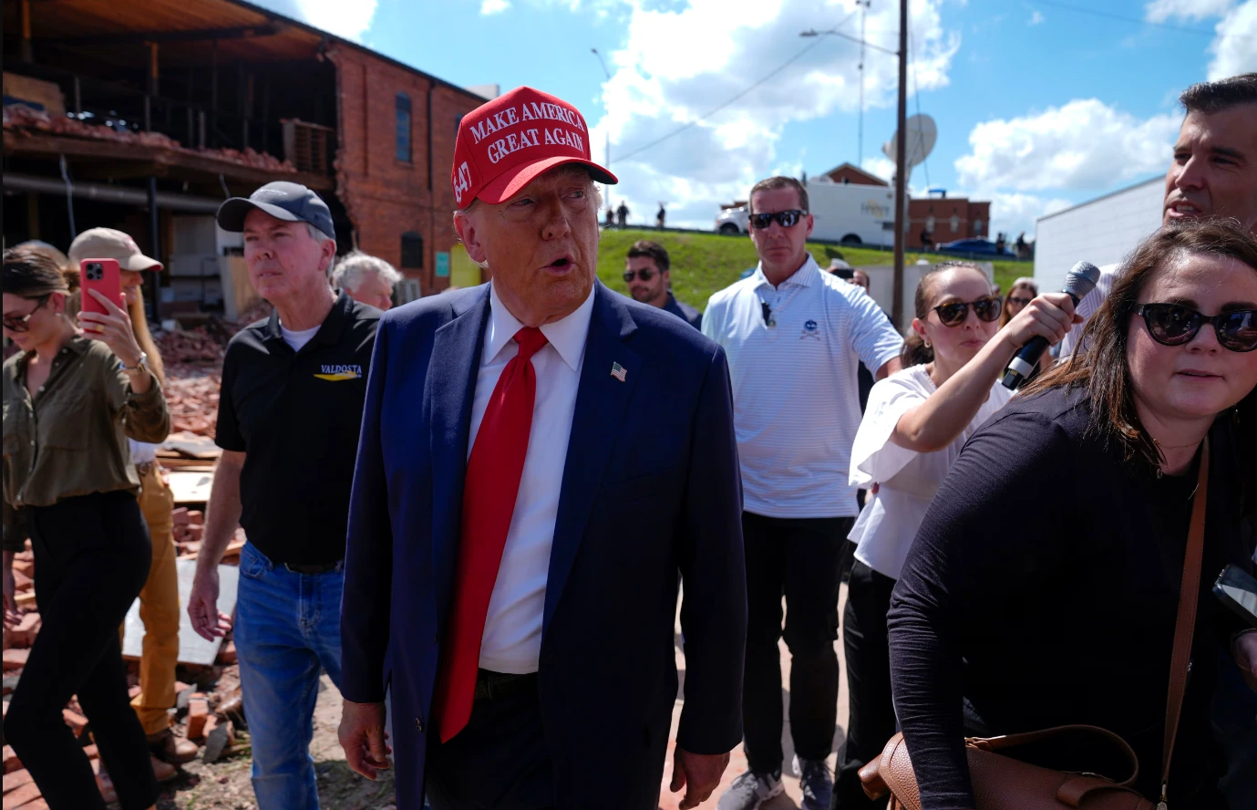 Trump visits hurricane hit Georgia while Harris wooes voters in Michigan