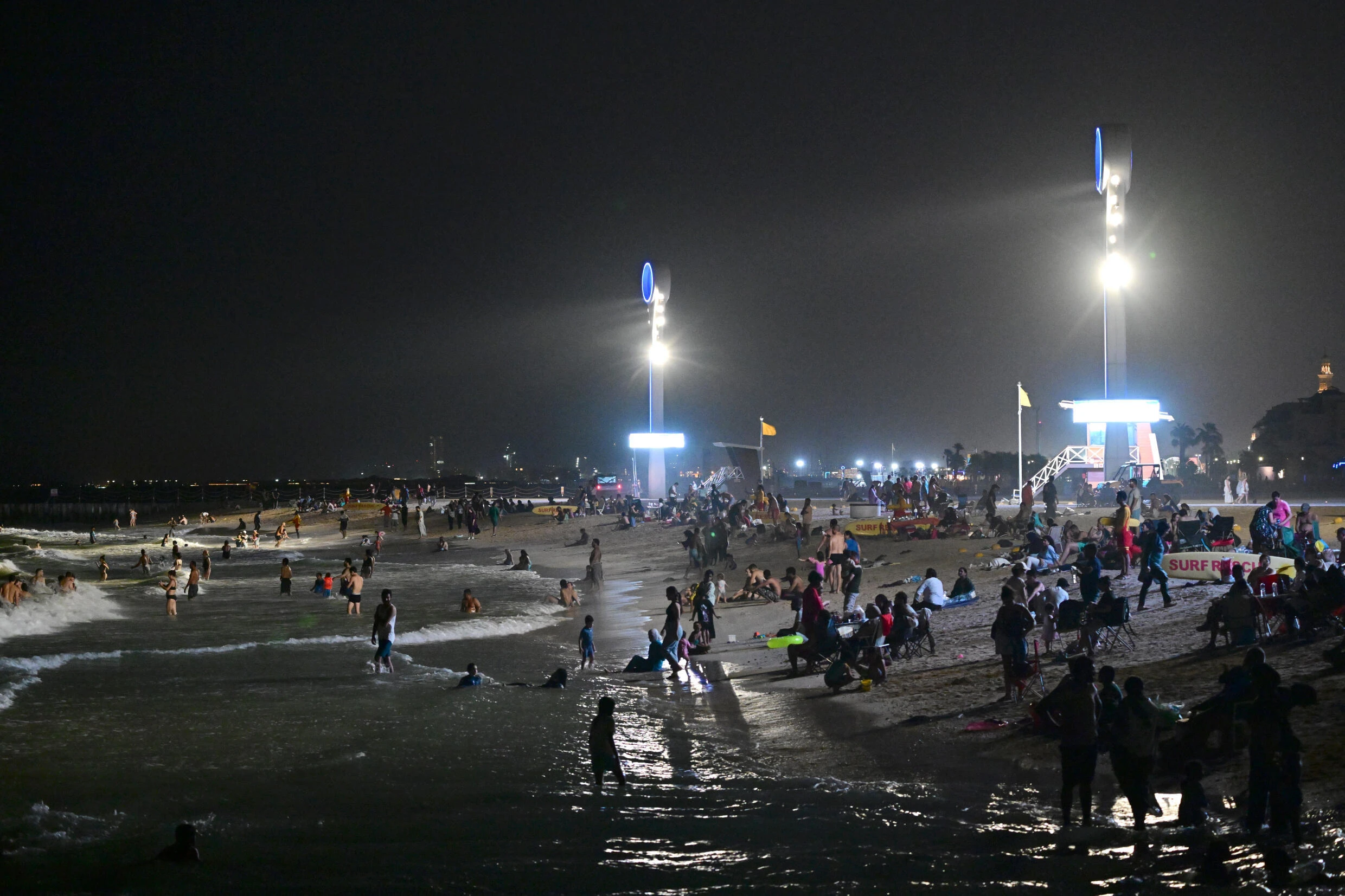 Too hot by day, Dubai's floodlit beaches are packed at night