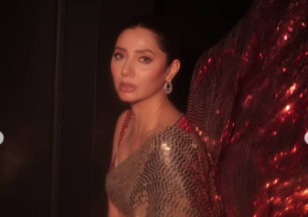 Mahira Khan sets hearts racing with hot poses on couch in sparkling red Saree